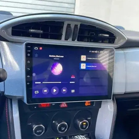 Car dashboard with a touchscreen display and gear shift lever.