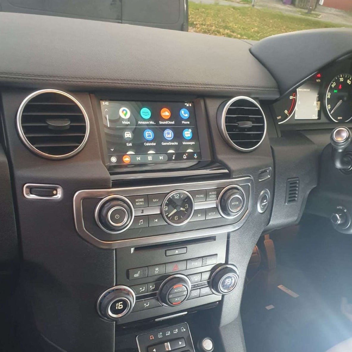 Land Rover interior with the integrated wireless CarPlay system displayed on the infotainment screen.