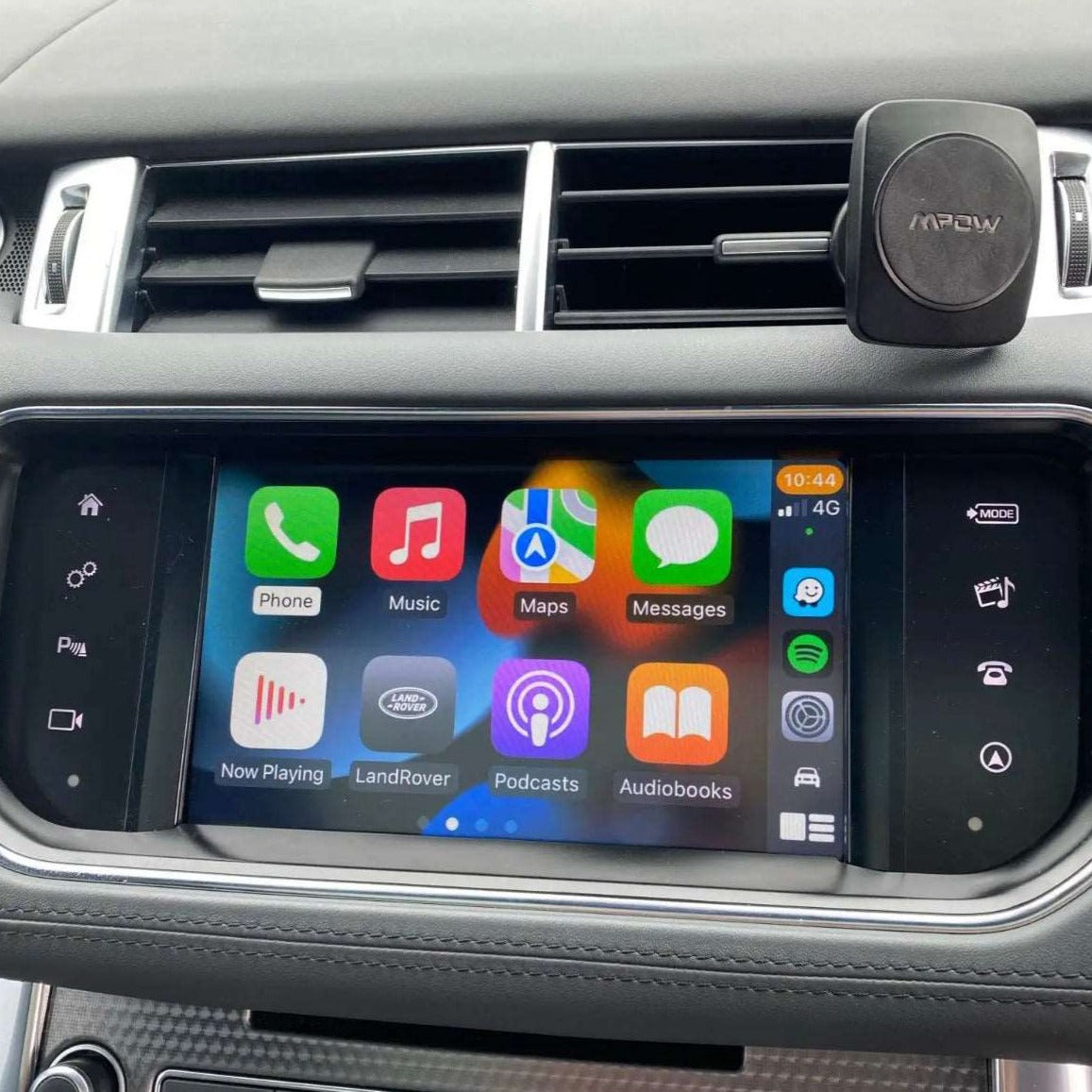 Newer Land Rover interior showing the integrated wireless Apple CarPlay interface on the infotainment screen.