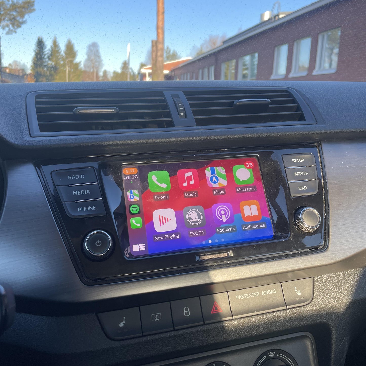 Skoda interior dashboard with the integrated wireless Apple CarPlay apps displayed on the infotainment screen.