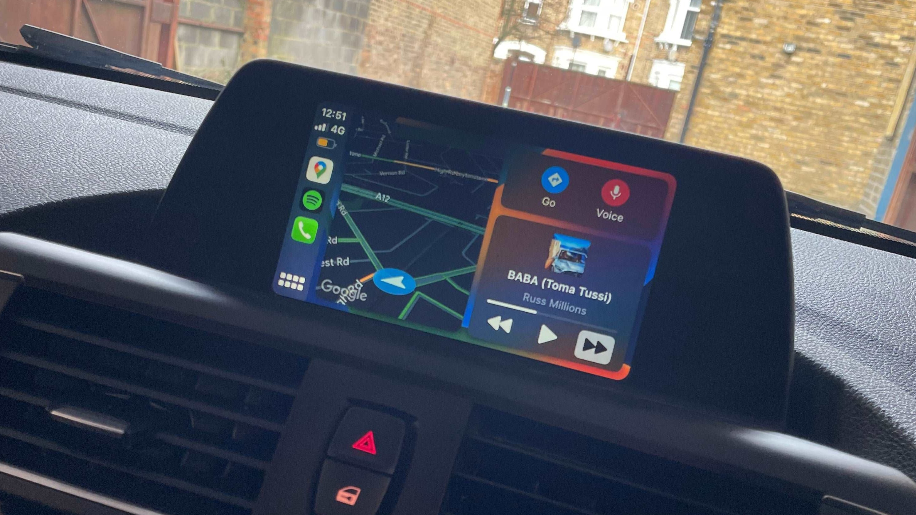 "CarPlay box interface on in-car display showing Apple CarPlay home screen with apps like Google Maps and music"