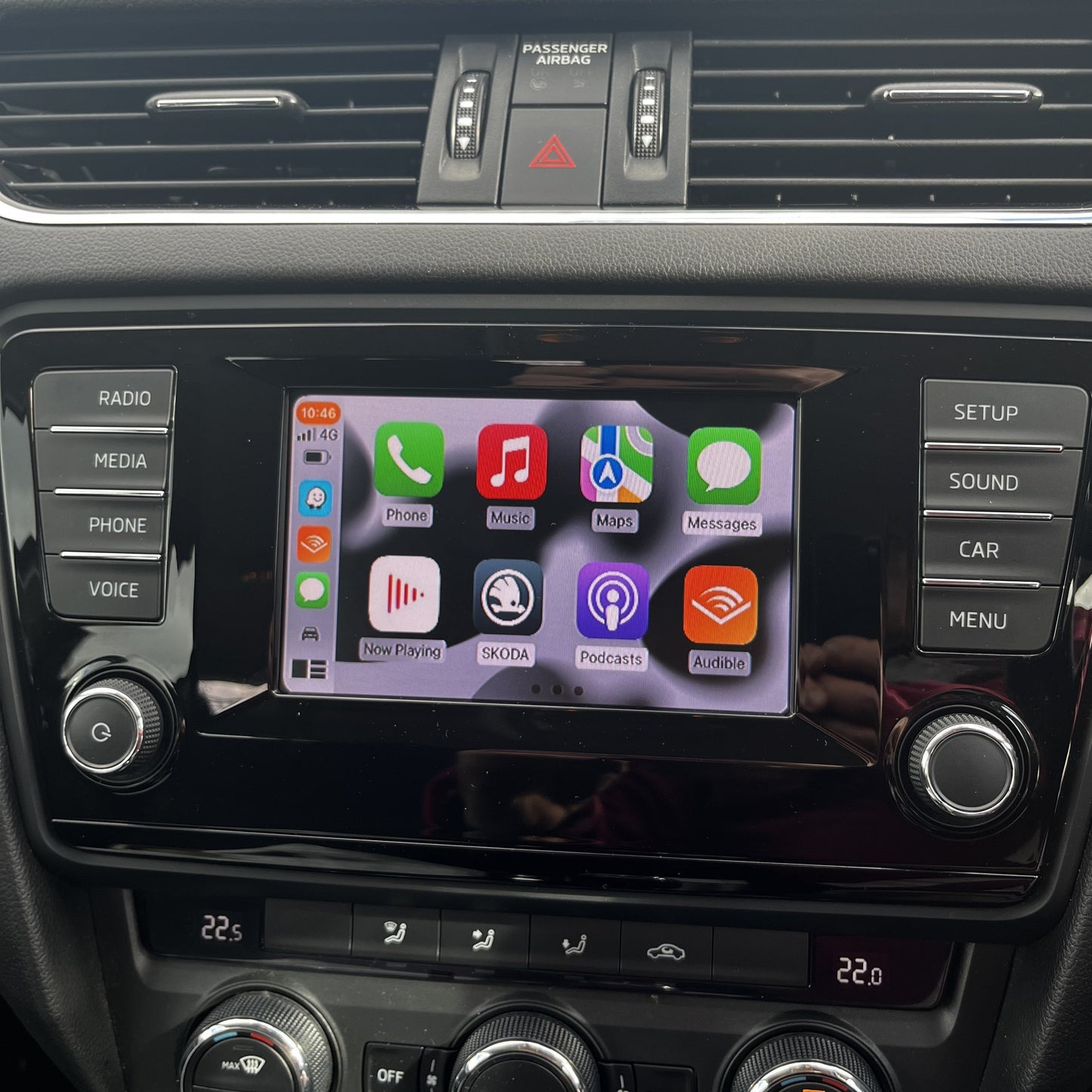 Skoda infotainment screen displaying integrated wireless Apple CarPlay apps.
