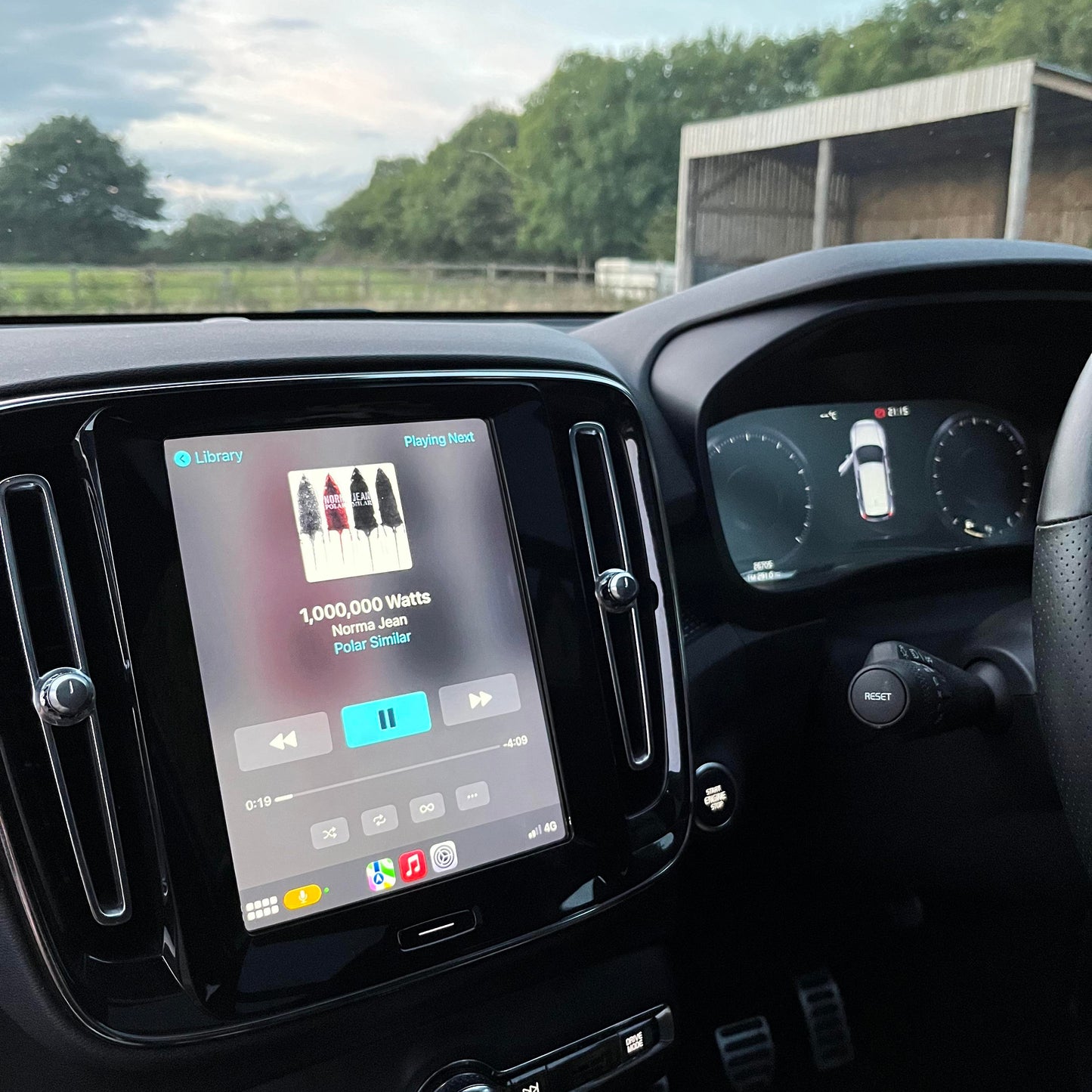 Newer Volvo interior with the vertical infotainment screen displaying the integrated wireless Apple CarPlay system.